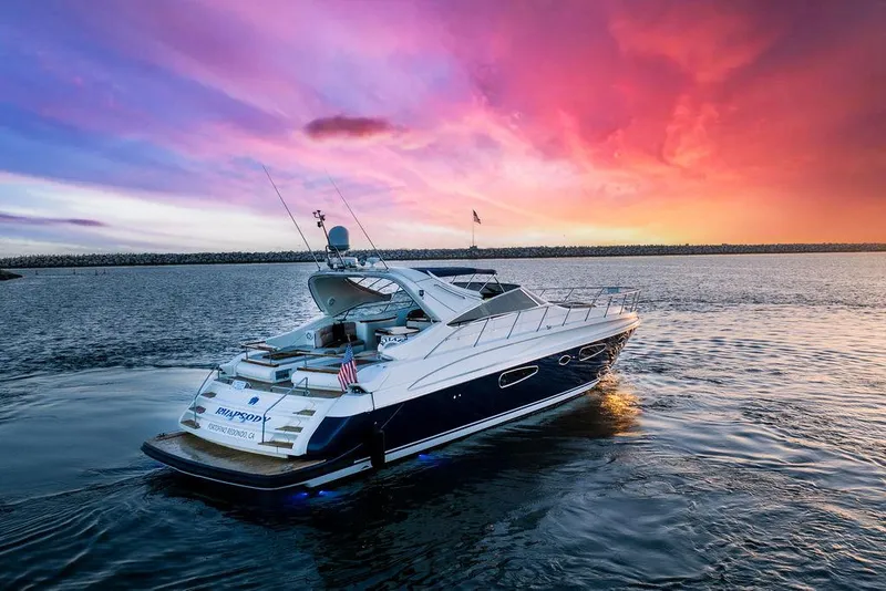 Slide: The Image of Riva 59 Mercurius yacht cruising at sunset, 2004 model, vibrant sky in background. - 34