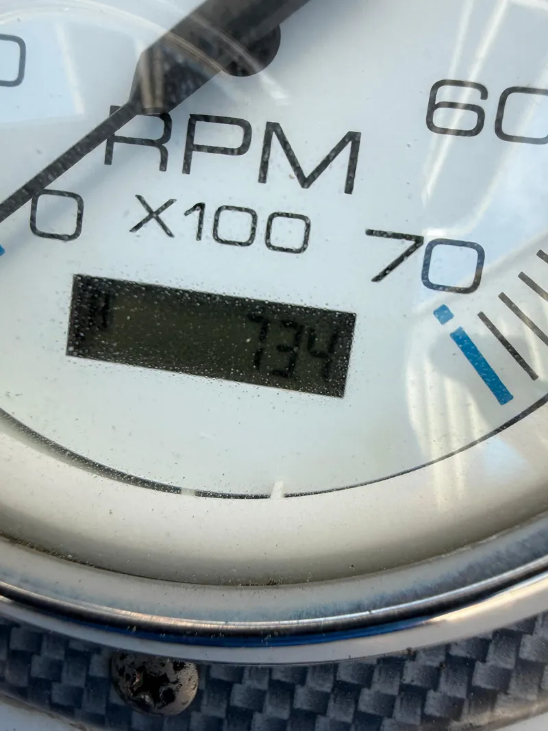 Slide: The Image of Close-up of a 2013 Carolina Skiff 218 DLV RPM gauge displaying 734 RPM. - 10