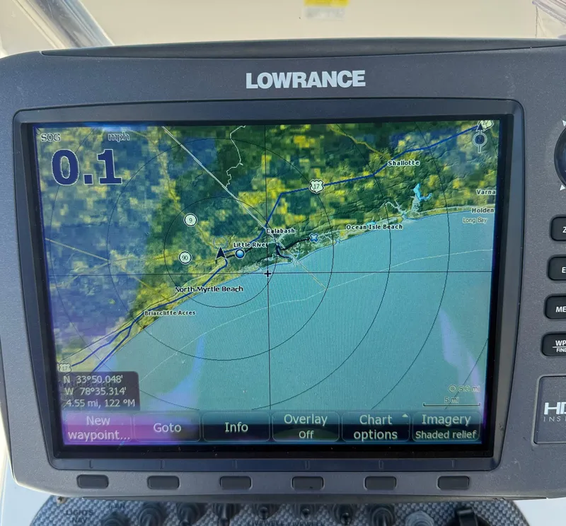 Slide: The Image of Lowrance GPS display on a 2013 Carolina Skiff 218 DLV, showing coastal navigation map. - 11