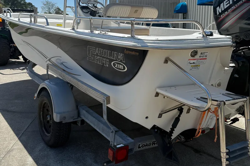 Slide: The Image of 2013 Carolina Skiff 218 DLV boat on trailer, rear view, outdoor setting. - 13