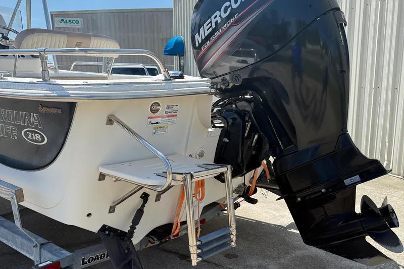 Slide: The Image of 2013 Carolina Skiff 218 DLV boat with Mercury outboard motor, rear view. - 14