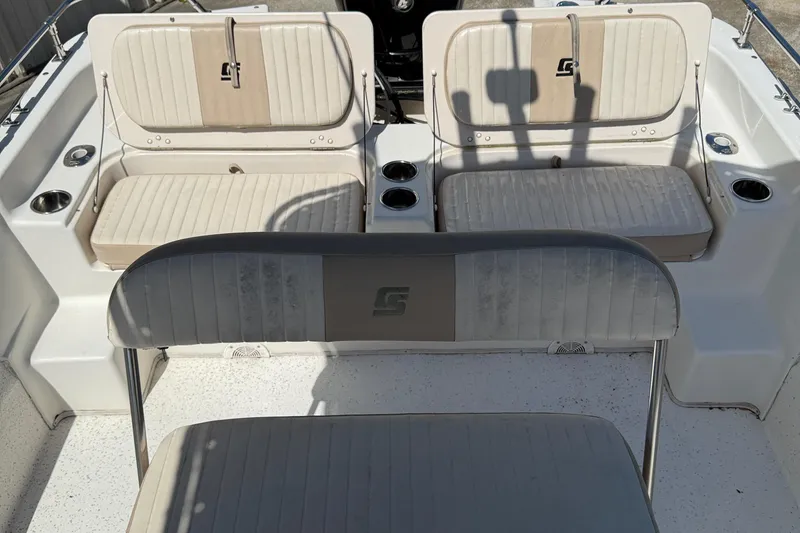 Slide: The Image of 2013 Carolina Skiff 218 DLV boat interior with seating and cup holders. - 17