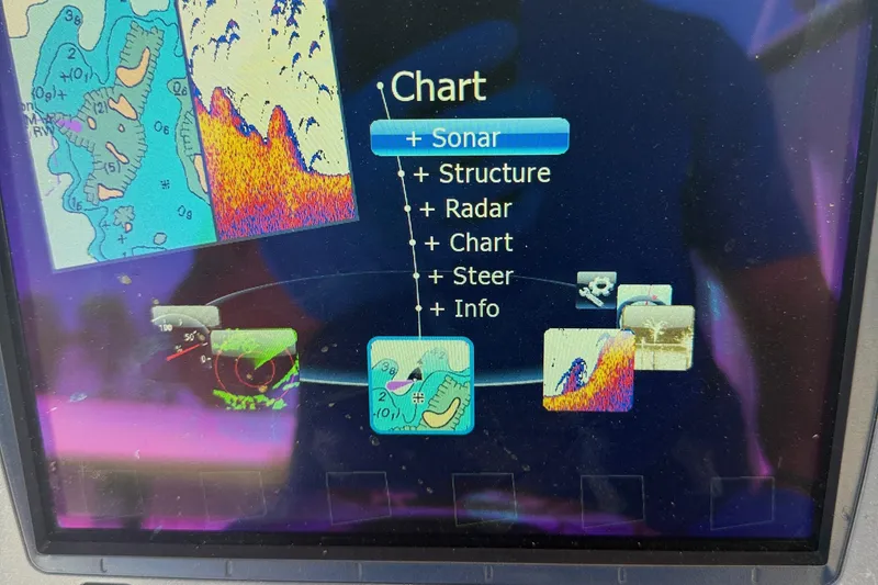 Slide: The Image of Boat navigation display showing sonar, structure, radar, chart, steer, and info options. Carolina Skiff 218 DLV. - 19