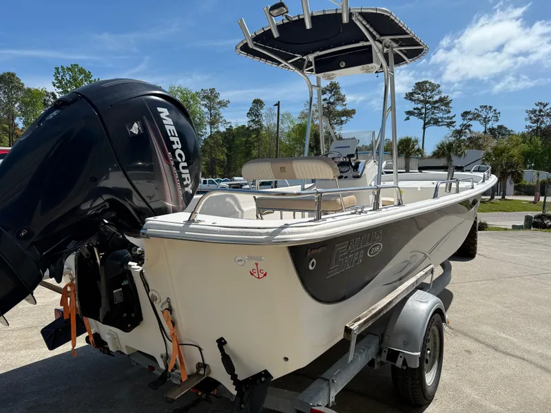 Slide: The Image of 2013 Carolina Skiff 218 DLV boat on trailer with Mercury outboard motor. - 3