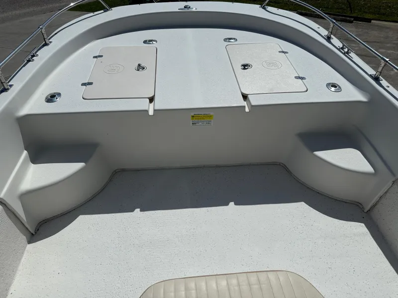 Slide: The Image of 2013 Carolina Skiff 218 DLV boat deck with storage compartments and seating. - 5