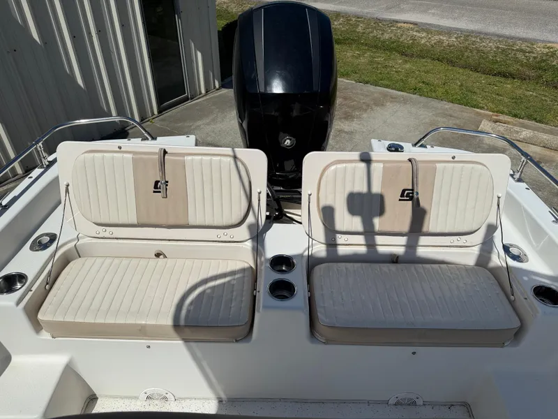 Slide: The Image of 2013 Carolina Skiff 218 DLV boat seats with outboard motor in background. - 8