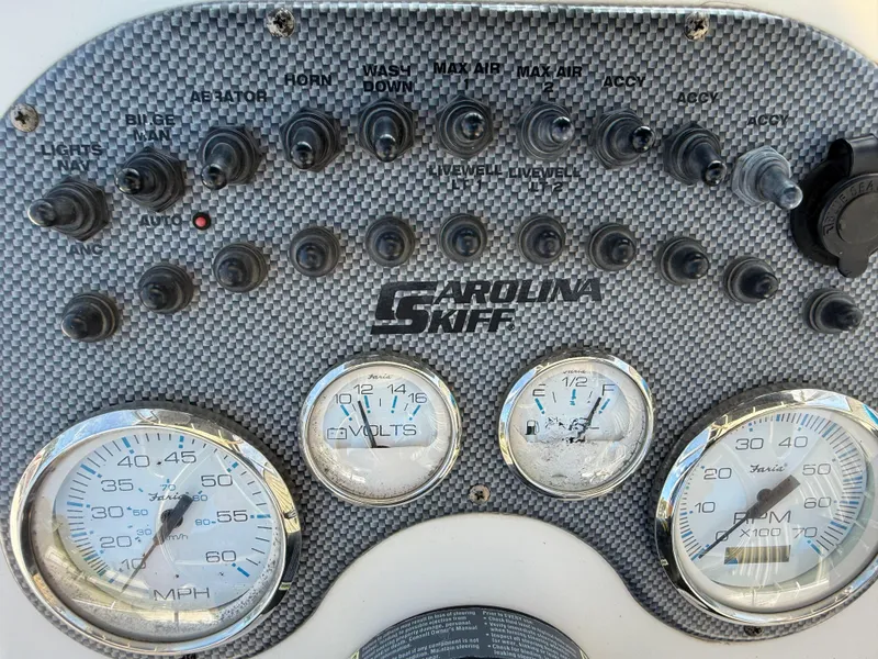 Slide: The Image of Dashboard of a 2013 Carolina Skiff 218 DLV boat with gauges and switches. - 9