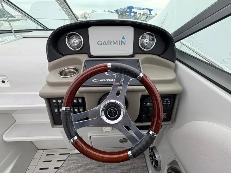 Slide: The Image of 2023 Crownline 264 CR boat dashboard with Garmin navigation and stylish steering wheel. - 6