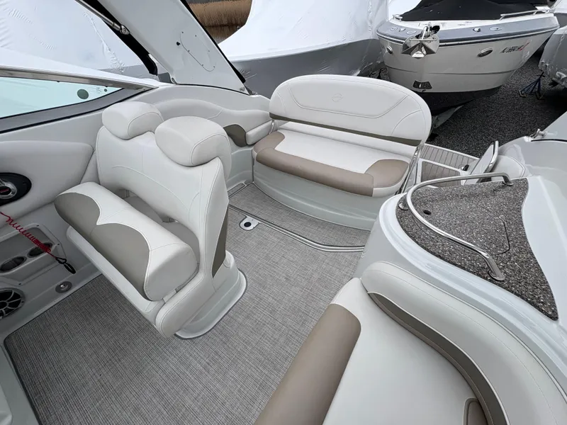 Slide: The Image of 2023 Crownline 264 CR boat interior with white and beige seating. - 8