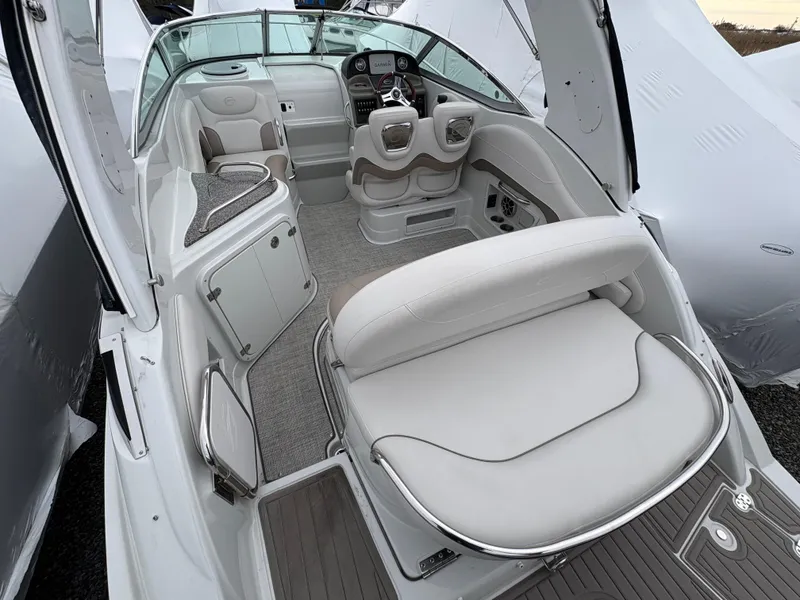 Slide: The Image of 2023 Crownline 264 CR boat interior with white seating and modern dashboard. - 9