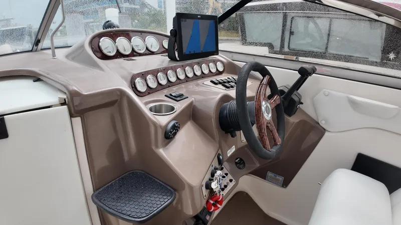 Slide: The Image of 2005 Regal Commodore 2860 boat dashboard with steering wheel and instrument panel. - 14