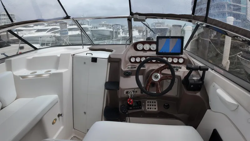 Slide: The Image of 2005 Regal Commodore 2860 boat cockpit with steering wheel and navigation instruments. - 15