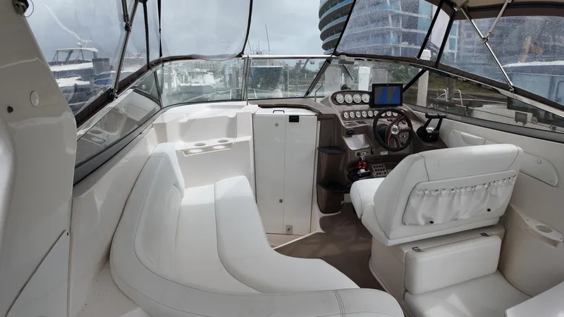 Slide: The Image of 2005 Regal Commodore 2860 boat interior with white seating and modern dashboard. - 18