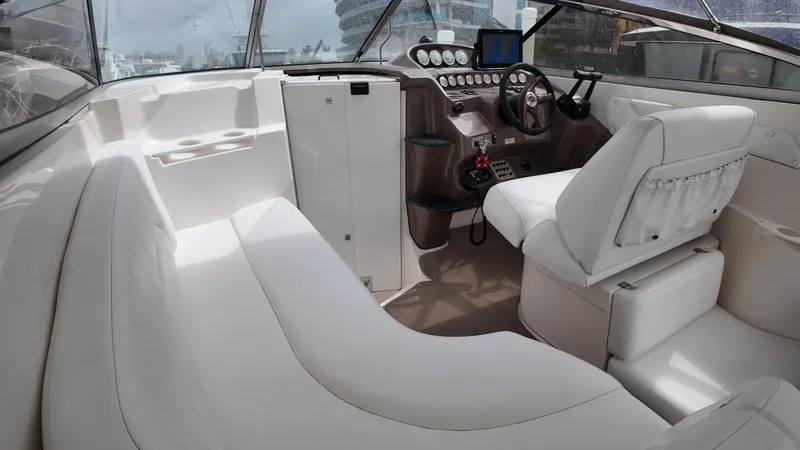 Slide: The Image of 2005 Regal Commodore 2860 boat interior with white seating and modern dashboard. - 22
