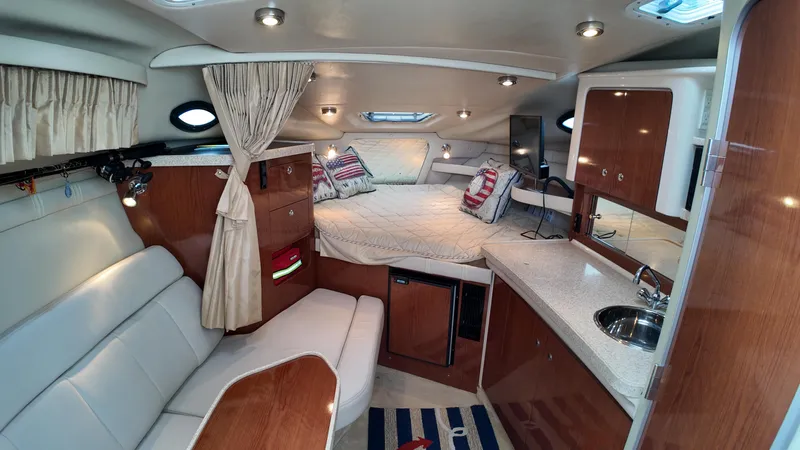 Slide: The Image of Interior of 2005 Regal Commodore 2860 boat with cozy seating and sleeping area. - 23