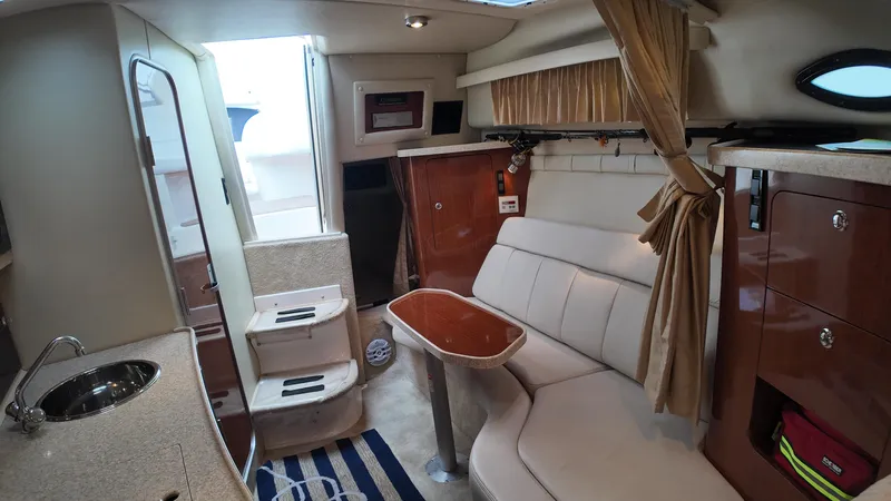 Slide: The Image of 2005 Regal Commodore 2860 cabin interior with seating, table, and kitchenette. - 25