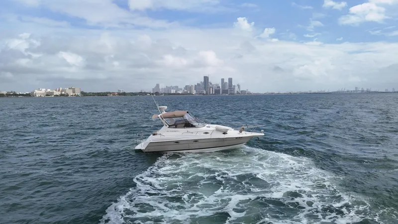 Slide: The Image of 2005 Regal Commodore 2860 yacht cruising near city skyline on a sunny day. - 9