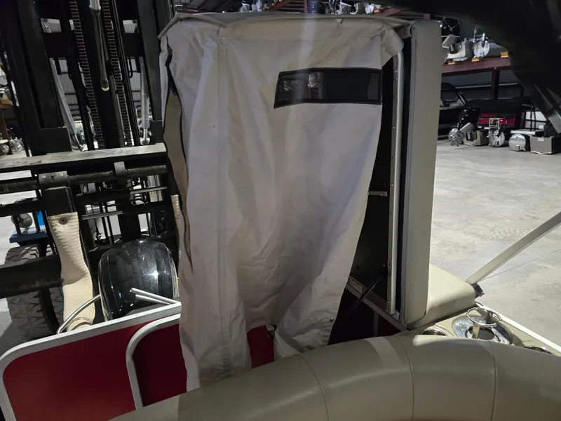 Slide: The Image of 2022 Premier 210 SunSation RE boat interior with protective cover in storage facility. - 10