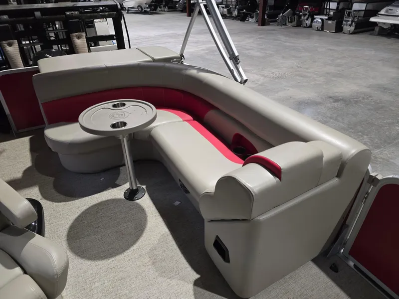 Slide: The Image of 2022 Premier 210 SunSation RE boat interior with beige and red seating, round table. - 13