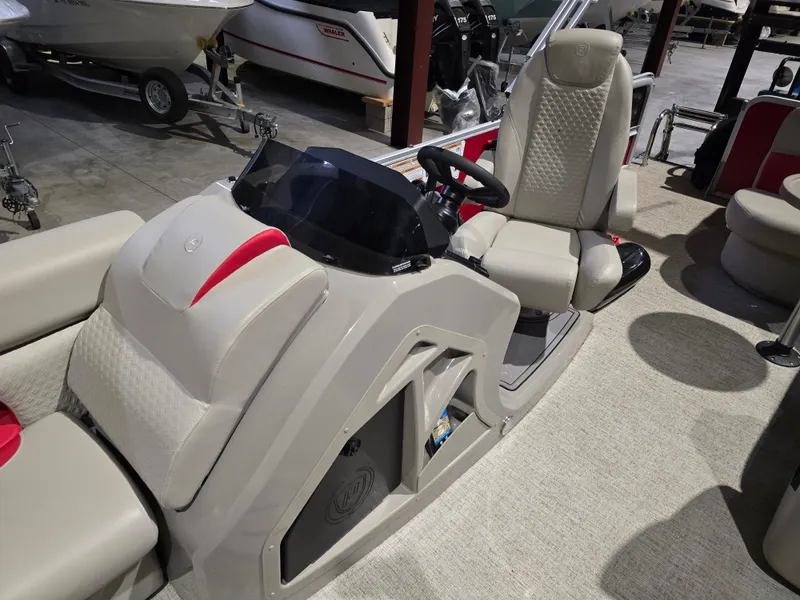 Slide: The Image of 2022 Premier 210 SunSation RE boat interior with steering console and seating. - 14