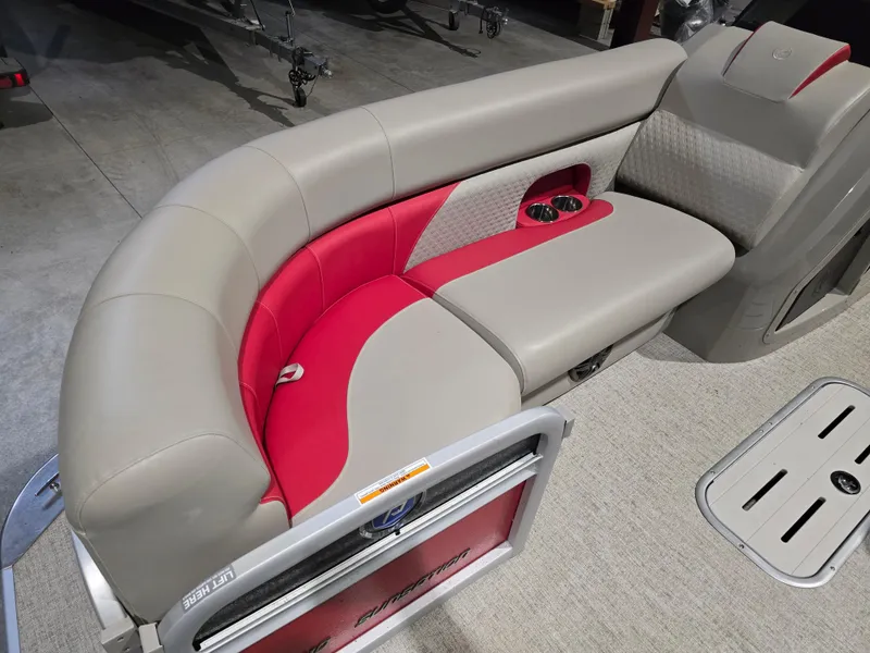Slide: The Image of 2022 Premier 210 SunSation RE boat seating with red and beige upholstery, cup holders, and storage. - 15