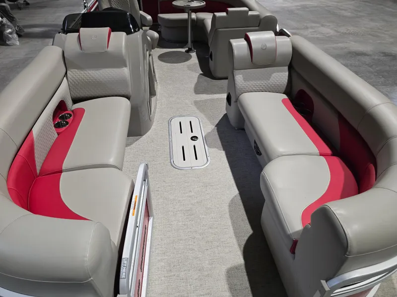 Slide: The Image of 2022 Premier 210 SunSation RE pontoon boat interior with beige and red seating. - 17