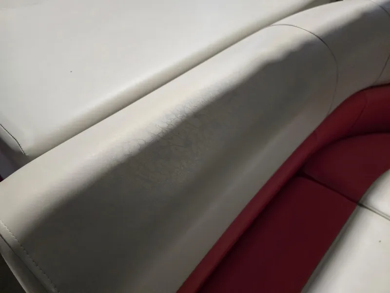 Slide: The Image of Close-up of 2022 Premier 210 SunSation RE boat seating, featuring white and red upholstery. - 5