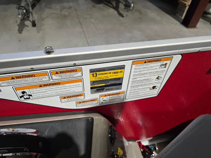 Slide: The Image of Warning labels on 2022 Premier 210 SunSation RE boat, maximum capacity 13 persons or 1950 lbs. - 6