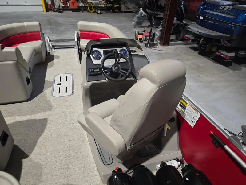 Slide: The Image of 2022 Premier 210 SunSation RE pontoon boat interior with steering console and seating. - 8