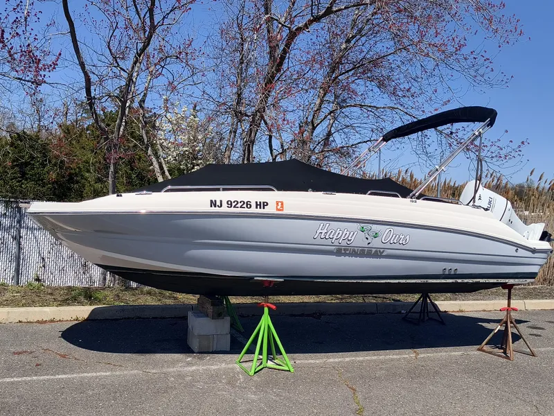 Slide: The Image of 2021 Stingray 192 SC boat on stands, covered, with registration NJ 9226 HP. - 1