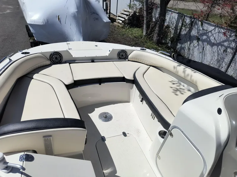 Slide: The Image of 2021 Stingray 192 SC boat interior with beige seating and black accents. - 5
