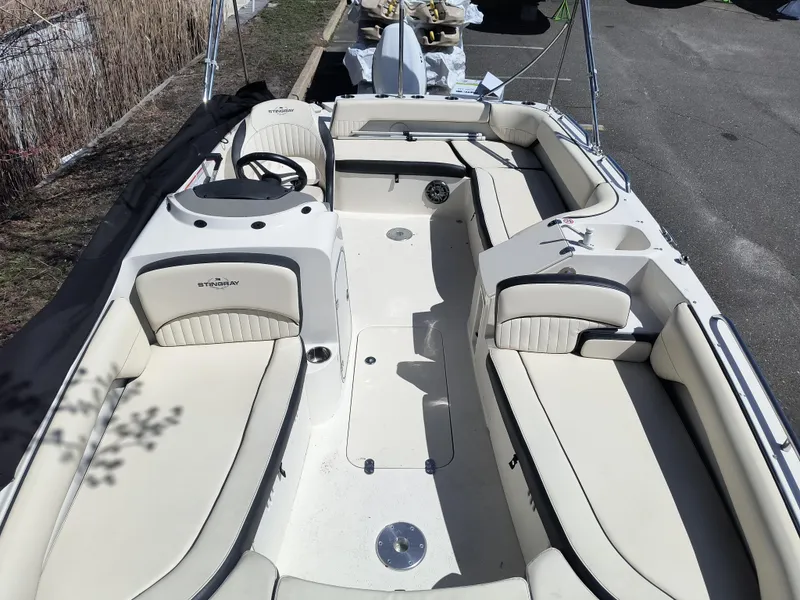 Slide: The Image of 2021 Stingray 192 SC boat interior with spacious seating and steering wheel. - 6