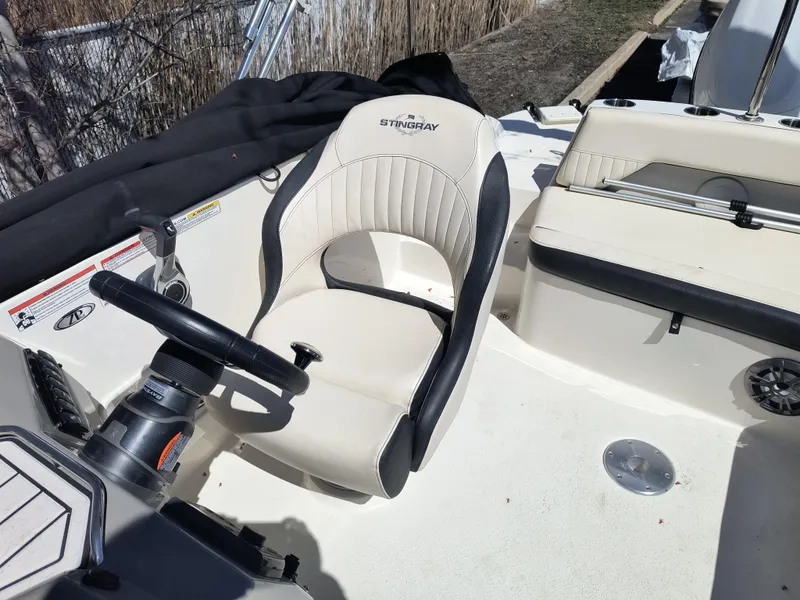 Slide: The Image of 2021 Stingray 192 SC boat interior with steering wheel and seating. - 8