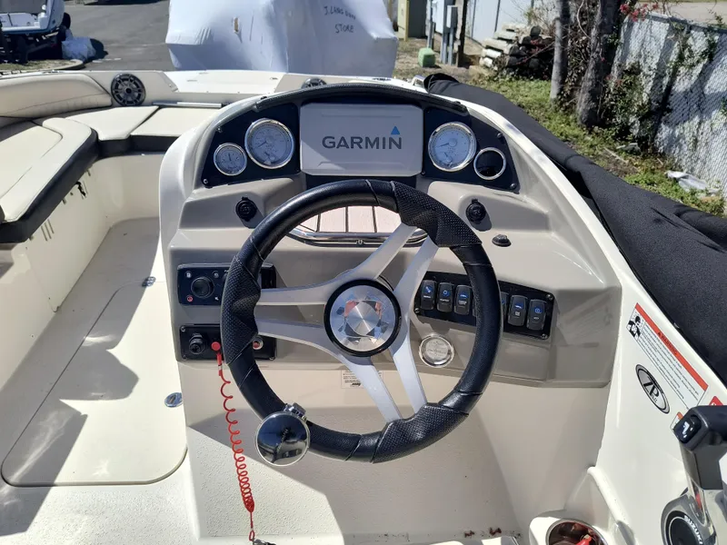 Slide: The Image of 2021 Stingray 192 SC boat dashboard with Garmin navigation system and steering wheel. - 9