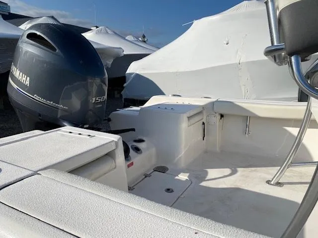 Slide: The Image of 2020 Tidewater 198CC boat with Yamaha 150 engine, docked and covered. - 3