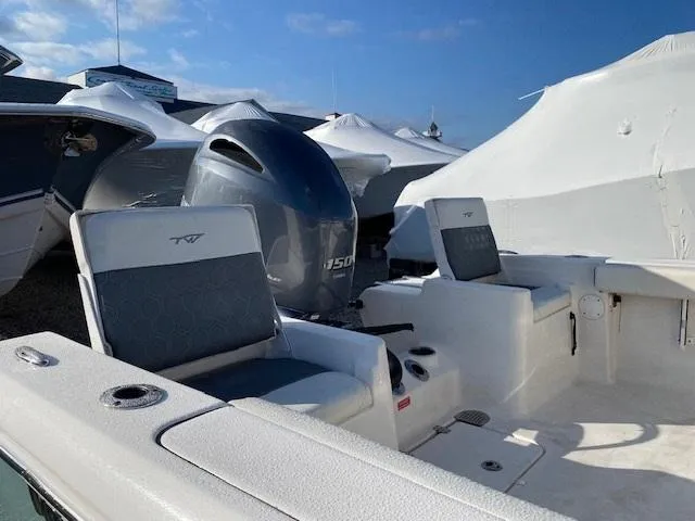 Slide: The Image of 2020 Tidewater 198CC boat with seating and outboard motor, under clear blue sky. - 4