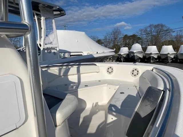 Slide: The Image of 2020 Tidewater 198CC boat interior with seating, speakers, and clear sky background. - 7