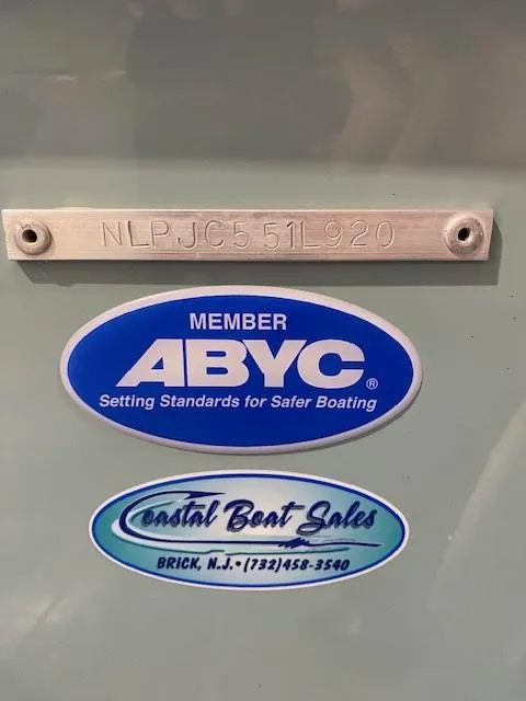 Slide: The Image of 2020 Tidewater 198CC boat with ABYC and Coastal Boat Sales stickers. - 9