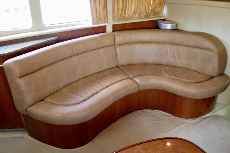 Slide: The Image of 2005 Sea Ray 390 Motor Yacht interior with curved leather seating. - 18