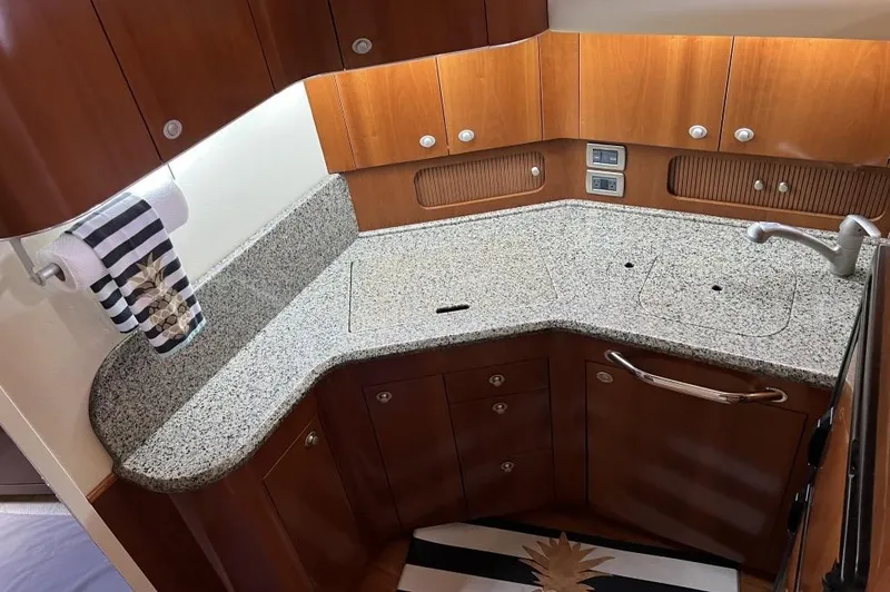 Slide: The Image of Luxurious kitchen area in 2005 Sea Ray 390 Motor Yacht with granite countertops and wooden cabinetry. - 22