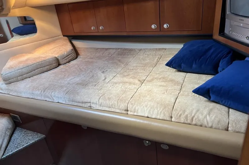Slide: The Image of Cozy cabin interior of 2005 Sea Ray 390 Motor Yacht with comfortable bedding and pillows. - 23