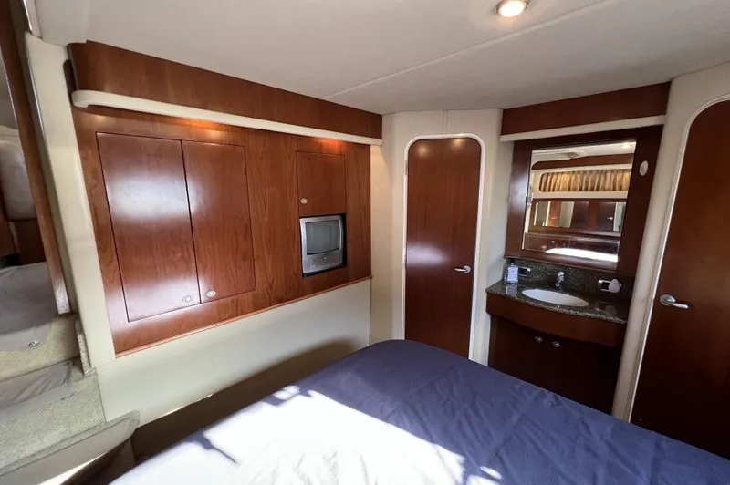 Slide: The Image of Luxurious 2005 Sea Ray 390 Motor Yacht cabin with wood paneling and compact TV. - 28