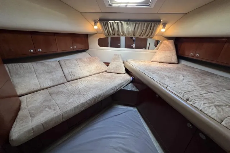 Slide: The Image of 2005 Sea Ray 390 Motor Yacht interior with cozy beige seating and wooden cabinetry. - 31
