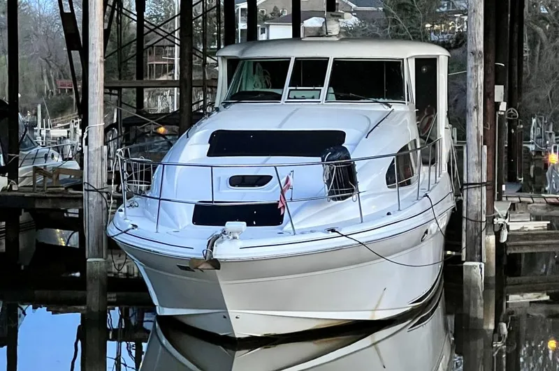 Slide: The Image of 2005 Sea Ray 390 Motor Yacht docked in a marina, front view. - 35