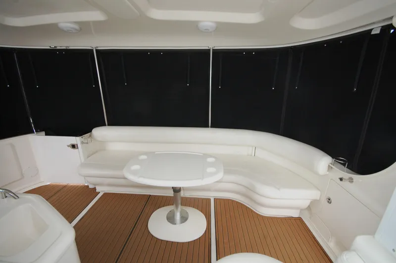 Slide: The Image of 2005 Sea Ray 390 Motor Yacht interior with white seating and wooden flooring. - 38