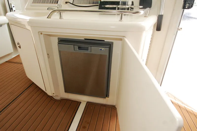 Slide: The Image of 2005 Sea Ray 390 Motor Yacht interior with built-in stainless steel appliance and wooden flooring. - 40