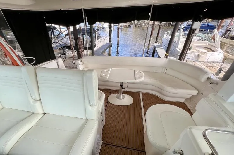 Slide: The Image of 2005 Sea Ray 390 Motor Yacht interior with white seating and wood flooring. - 8