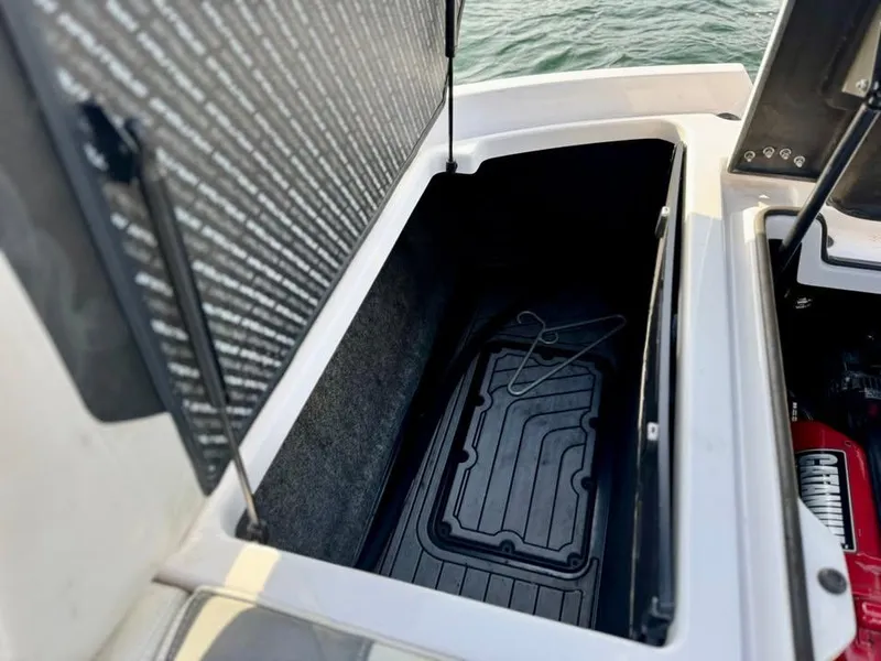 Slide: The Image of Open storage compartment in 2015 Nautique Super Air Nautique G21 boat. - 11