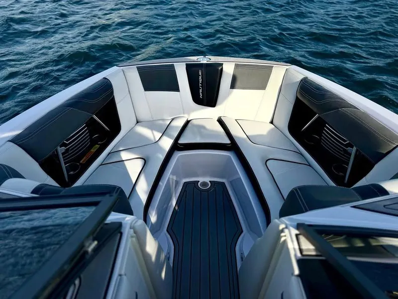 Slide: The Image of 2015 Nautique Super Air Nautique G21 boat interior with sleek seating and open water view. - 12