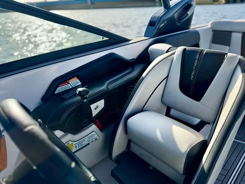 Slide: The Image of 2015 Nautique Super Air Nautique G21 interior with sleek seating and control panel. - 8